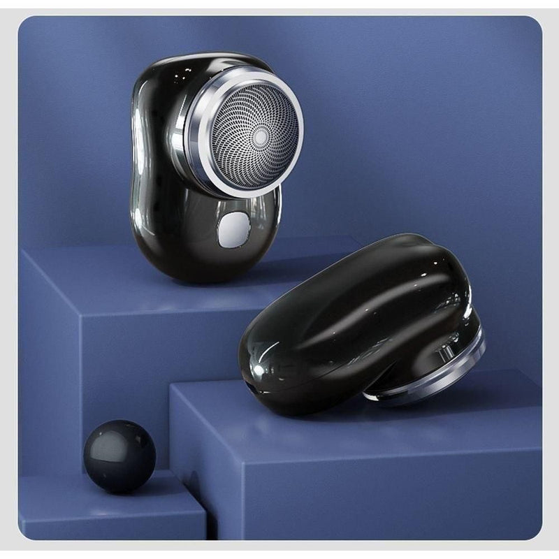 Trimini compact electric shaver in sleek black design with ergonomic grip, displayed on modern blue geometric blocks for grooming product showcase.